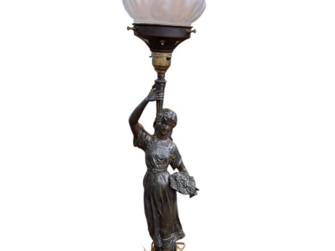 A spelter figure newel post lamp with frosted glass shade, 68cm high.