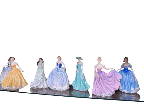 A collection of seven Royal Doulton and Royal Worcester lady figurines.
