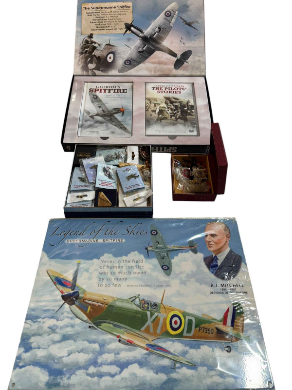 A collection of military badges, Defender of the Skies DVDs and Legend of the Skies wall sign.