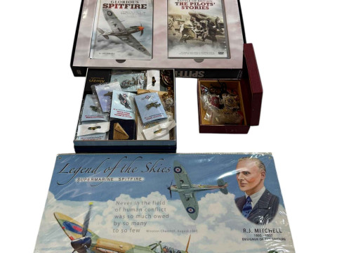 A collection of military badges, Defender of the Skies DVDs and Legend...