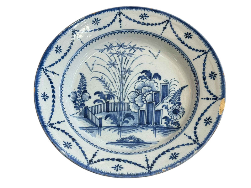 18th Century blue and white Delft charger, decorated with garden scene, 32cm dia.