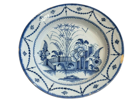 18th Century blue and white Delft charger, decorated with garden scene,...