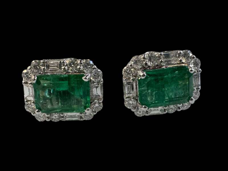 Pair of 18 carat emerald and diamond cluster earrings, rectangular emerald surrounded by baguette and brilliant cut diamonds.
