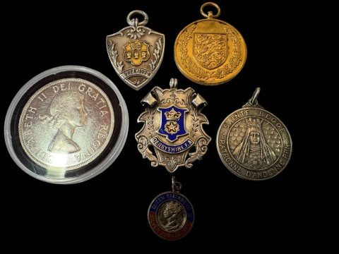 Canadian silver dollar and five silver medals.