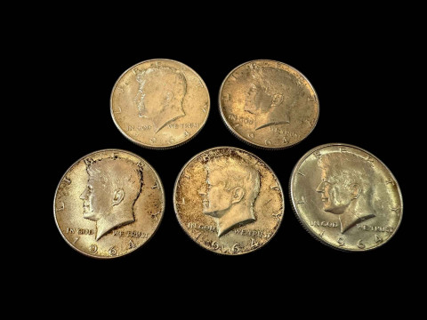 Five silver half dollars.