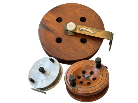 Three fishing reels, including large mahogany fishing reel with silver...