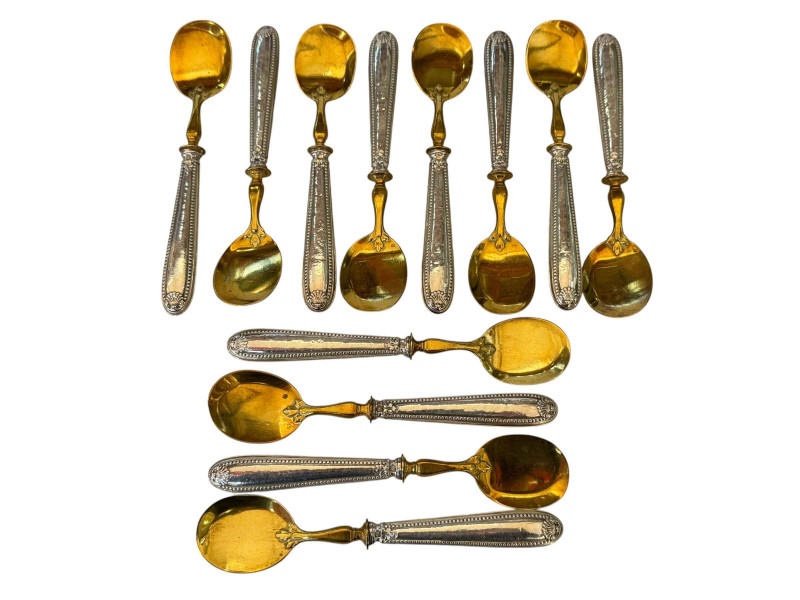 Set of twelve French silver handled and gilt dessert spoons.