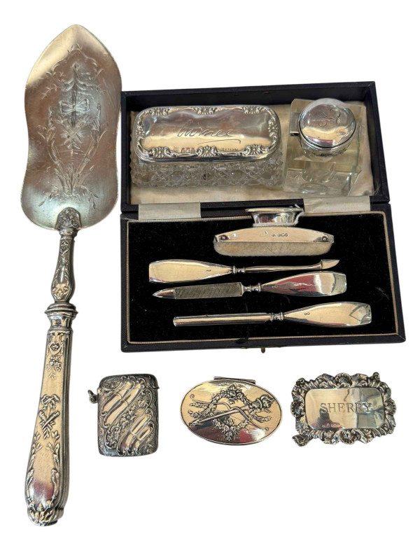 Collection of seven silver items comprising vesta, box, sherry label, inkwell, jar, manicure set and silver handled server.