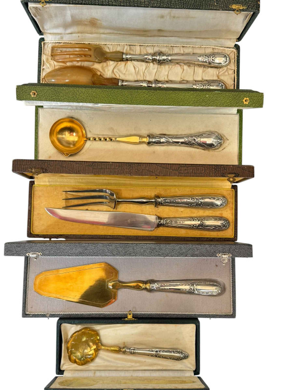 Five cased French silver and silver plate ornate handled servers, some with gilt bowls.
