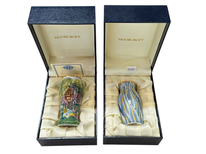 Two Moorcroft enamel vases 'Eves Garden' 15/100 with certificate and 'Enaphine Fish Shoal' 21/250 no certificate.