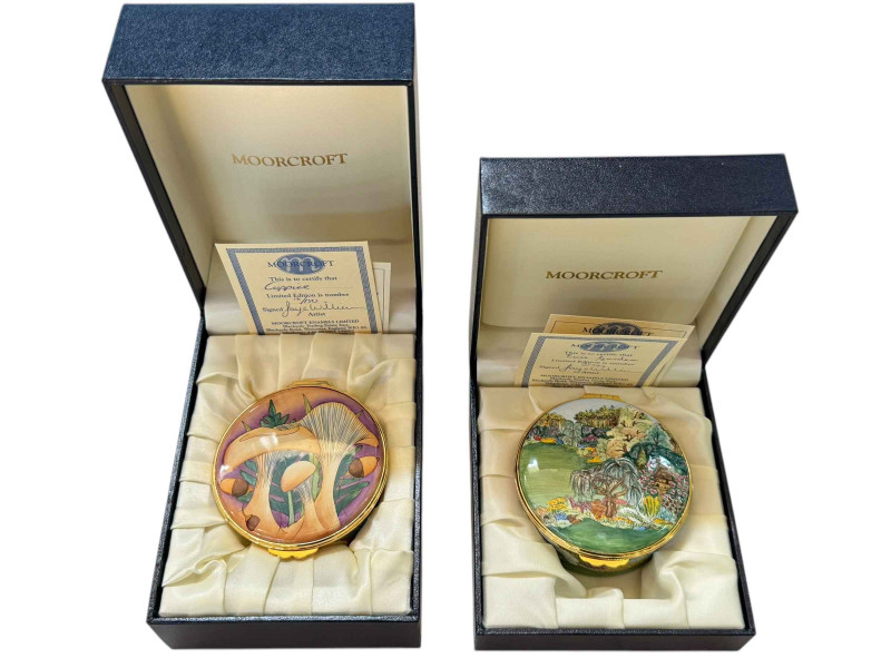 Two Moorcroft enamel trinket boxes 'Eve's Garden' 21/100 with certificate and 'Coppice' 14/150 with certificate.