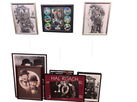 Collection of eleven Laurel & Hardy framed photographic prints, poster...