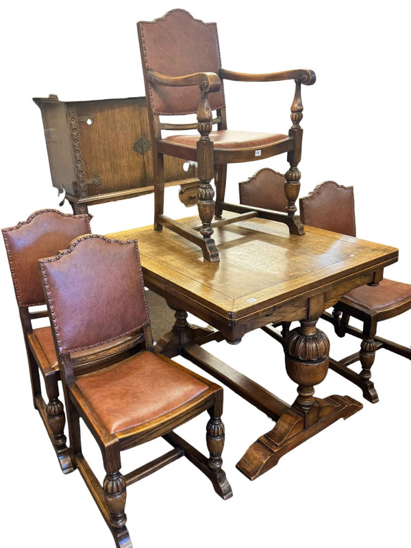 1930's oak two door cabinet on two drawer stand, draw leaf dining table and five dining chairs including one carver (7).