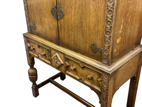 1930's oak two door cabinet on two drawer stand, draw leaf dining table and five dining chairs including one carver (7). thumbnail