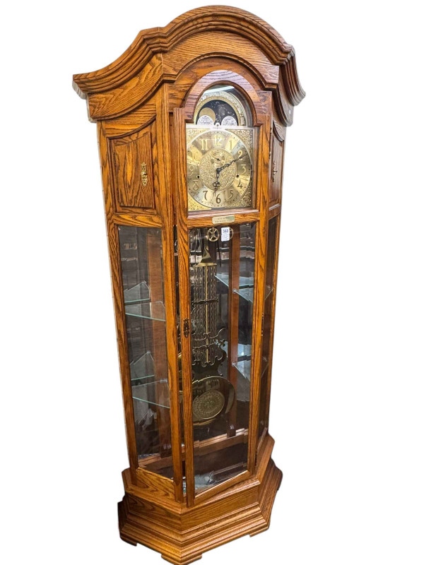 Oak cased American triple weight longcase clock having moon phase dial and canted corner display shelves, 209cm.