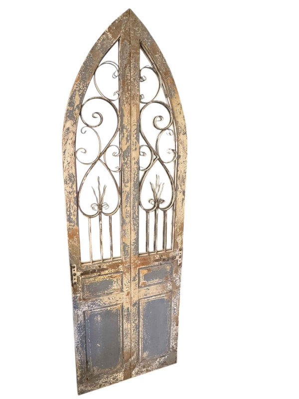 French style arched top mirror in the form of a door.