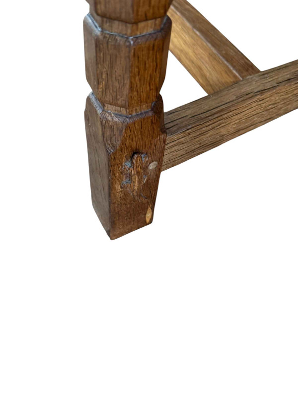 Derek 'Lizardman' Slater refectory oak dining table, 71cm by 214cm by 103cm together with a set of eight lattice and panel back dining chairs, including pair carvers.