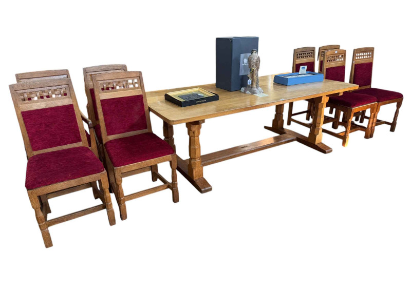 Derek 'Lizardman' Slater refectory oak dining table, 71cm by 214cm by 103cm together with a set of eight lattice and panel back dining chairs, including pair carvers.