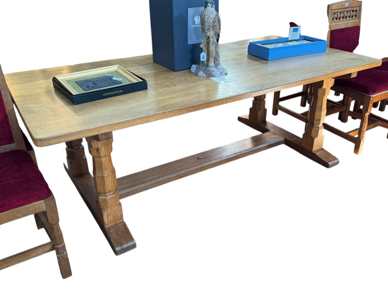 Derek 'Lizardman' Slater refectory oak dining table, 71cm by 214cm by 103cm together with a set of eight lattice and panel back dining chairs, including pair carvers.