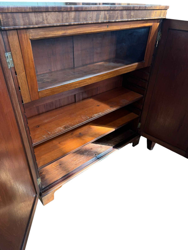 Victorian mahogany cabinet having two panelled doors enclosing a glazed fall front door above two adjustable shelves, 121cm by 107cm by 32.5cm.