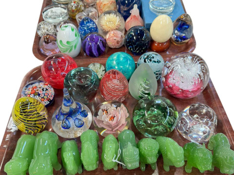 Collection of over thirty paperweights and green stone animal figures.
