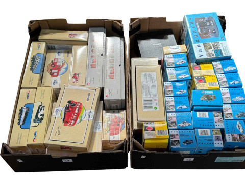 Two boxes of Corgi and Vanguard model vehicles.