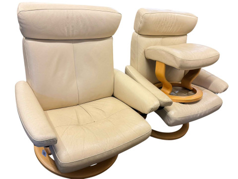 Pair of cream leather Stressless style swivel armchairs with one stool.