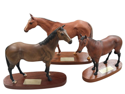 Three Beswick horses on wooden plinths, Mill Reef, Grundy and Psalm.
