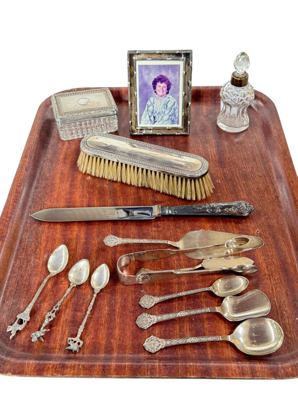 Silver photograph frame, silver collared scent bottle, silver topped trinket box, silver backed brush and cutlery.