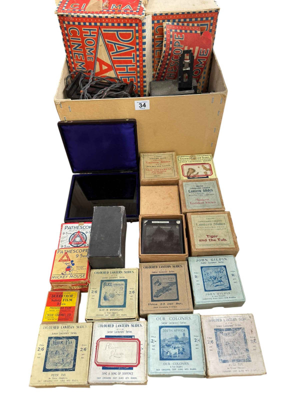 Pathescope Home Cinema with tape reels and a collection of boxed lantern slides.