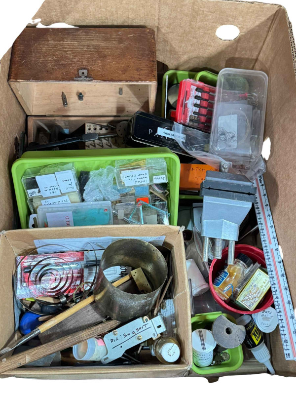 Three boxes of clock parts including movements, clock makers tools and accessories.