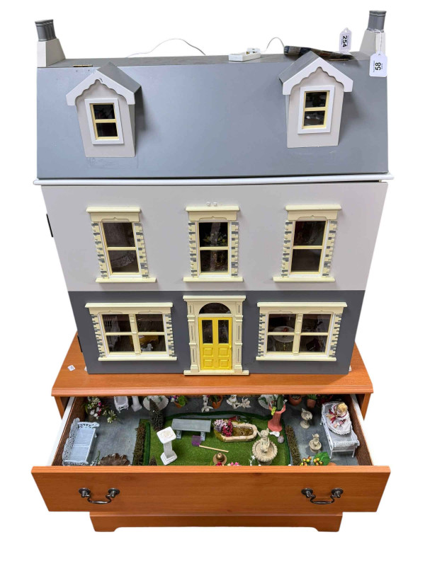 Large dolls house and furnishings and chest of accessories.