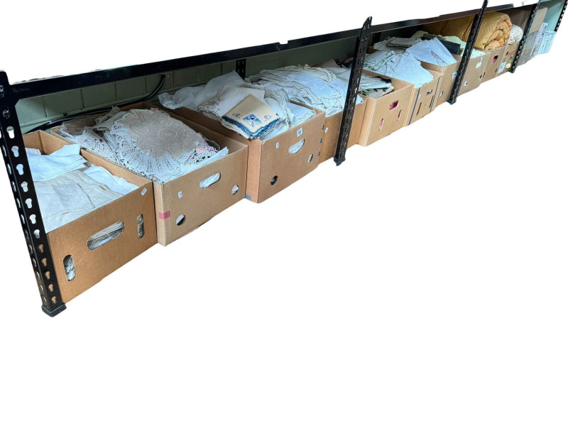 Eleven boxes of assorted linen, bed covers, eiderdowns, and two boxes of jewellery boxes.
