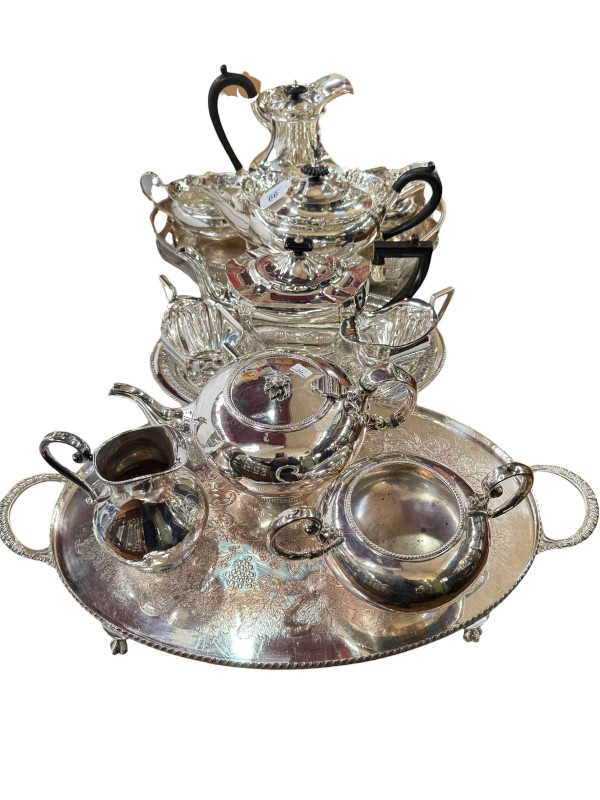 Four piece silver plated tea service and tray, and two three piece silver plated services with trays.