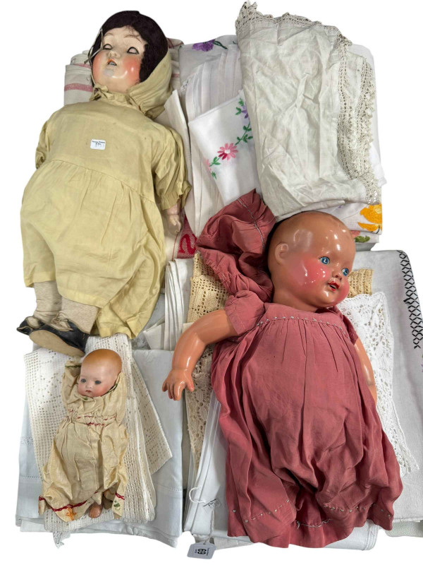 Armand Marseille bisque head doll and two other dolls, and a collection of lace and linen.
