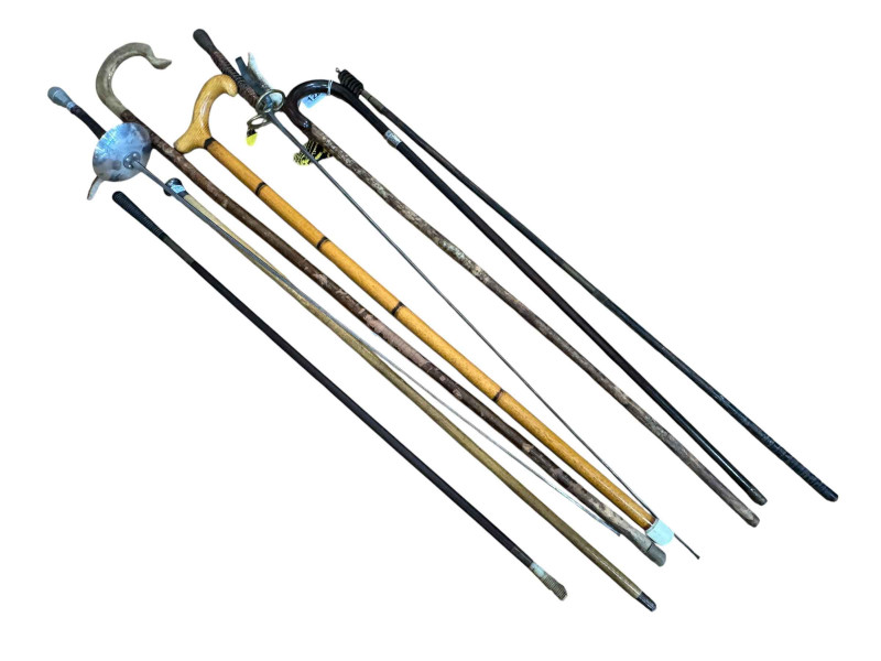 Collection of walking sticks and two fencing foils.