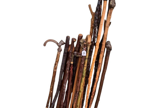 Large collection of walking sticks and staffs, sword, etc.
