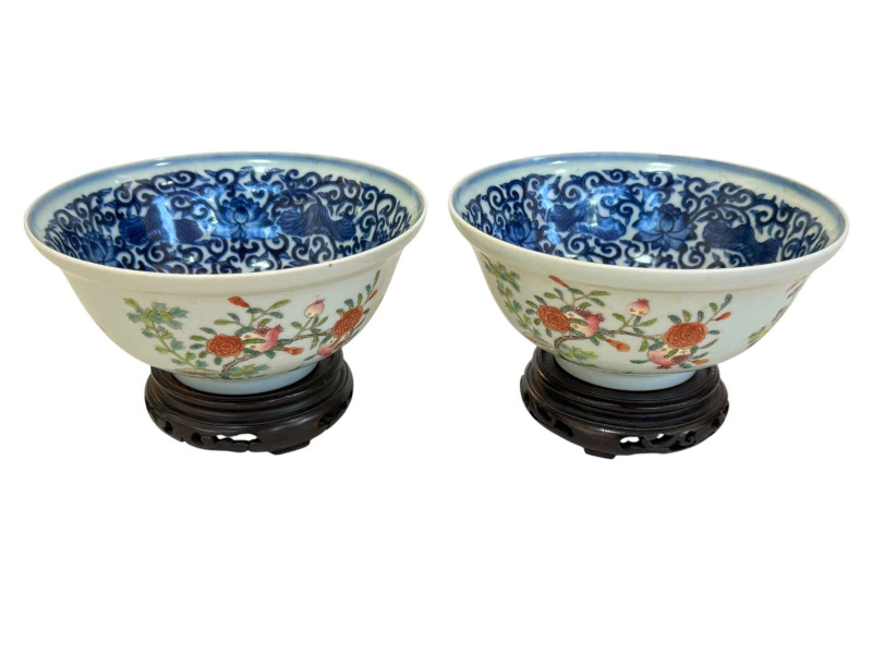 Pair of good quality Chinese porcelain bowls with blue and white interiors and plant decoration exterior, blue seal mark, 15cm diameter, with stands.