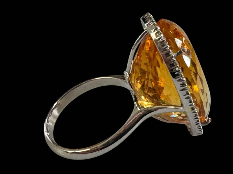 Large oval citrine and diamond cluster ring set in unmarked gold, diamond weight 0.40 carats, size N.