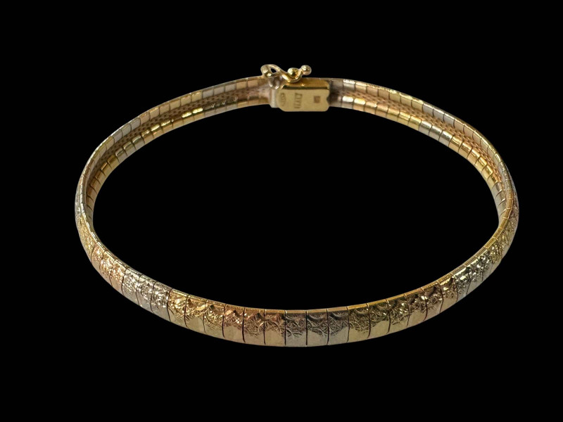 18 carat gold two colour bangle/bracelet with faceted decoration.