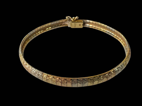 18 carat gold two colour bangle/bracelet with faceted decoration.