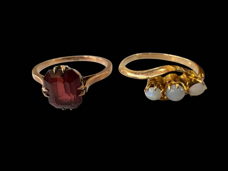 Two 9 carat gold opal and garnet rings.