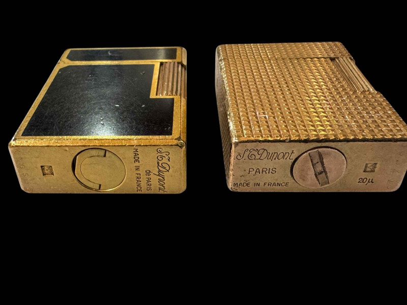 Two vintage Dupont, Paris cigarette lighters, gold plated and black lacquer.