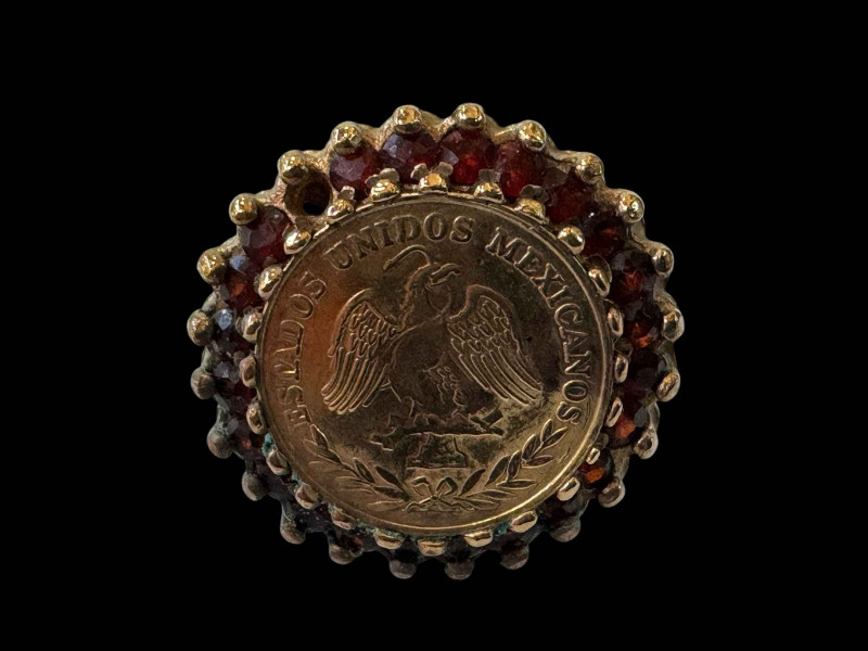 9 carat gold ring with Mexican coins and garnet border.