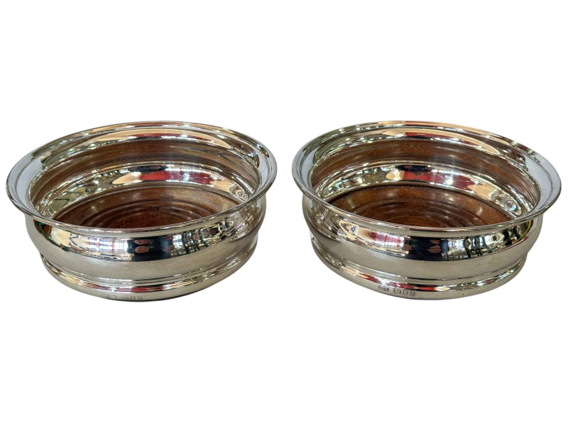 Pair silver wine bottle coasters, London 1963.