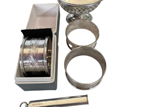 Three silver napkin rings, silver mustard pot, pencil holder and a fitting...