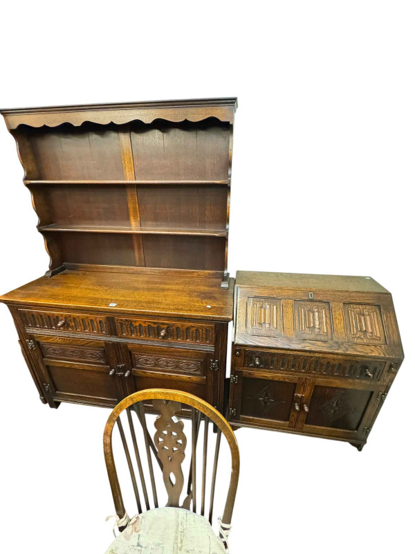 Old Charm style oak dresser, drop leaf table, six wheel back chairs and linen fold bureau.
