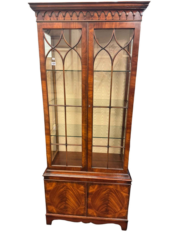 Mahogany display cabinet having double glazed doors above cupboard base.