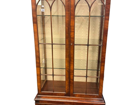 Mahogany display cabinet having double glazed doors above cupboard base.