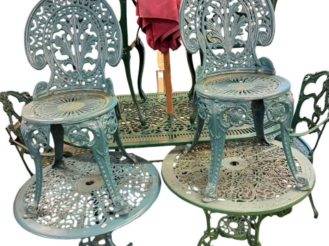 Cast aluminium garden table and four chairs, two smaller circular garden tables, pair of chairs and garden parasol. thumbnail